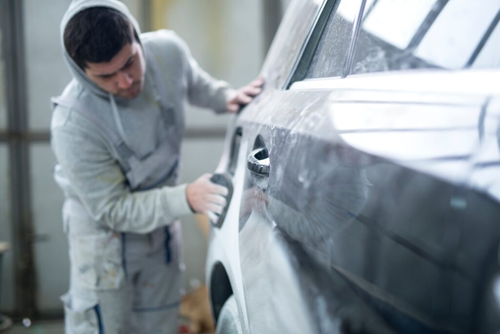 repairman preparing car painting workshop