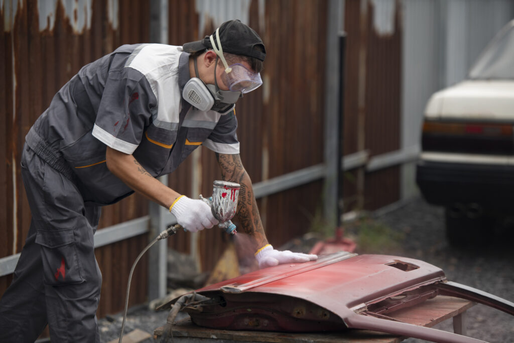 man painting car door side view